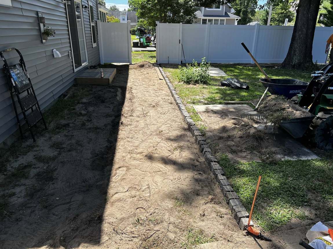 North Bay Landscape crew prepping a paver walkway base and edging in Ocean County, NJ